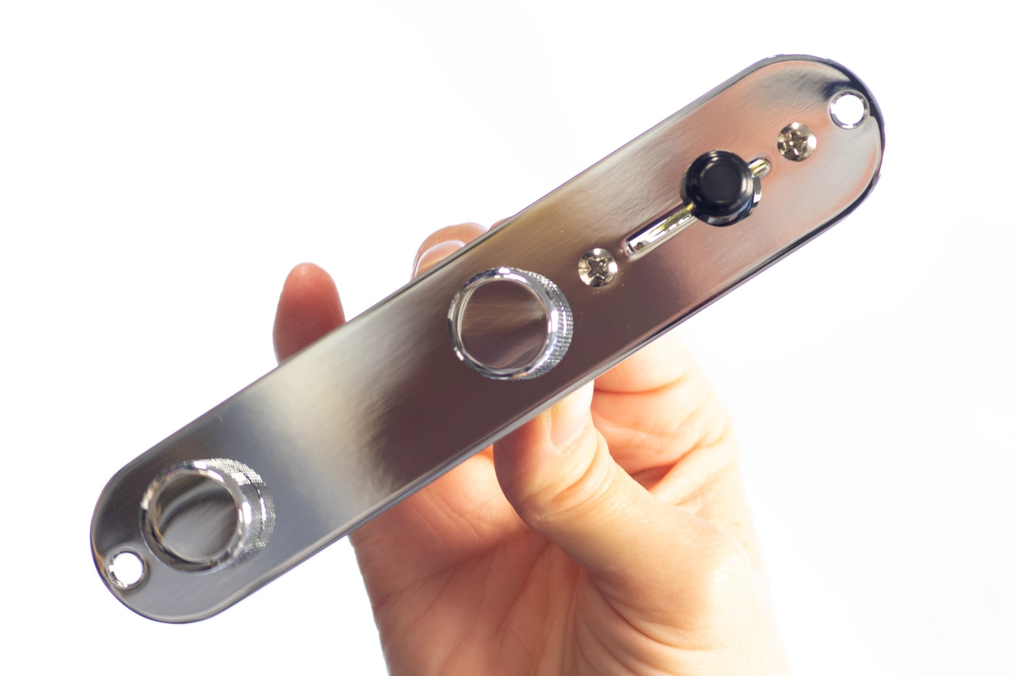 A hand held pre-wired Telecaster control plate with chrome control plate, chrome knobs and a black switch tip.