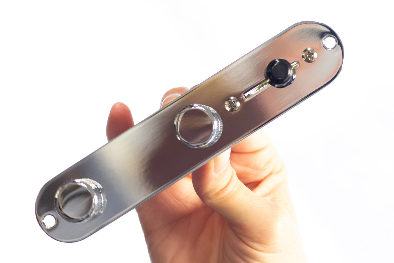 A hand held pre-wired Telecaster control plate with chrome control plate, chrome knobs and a black switch tip.